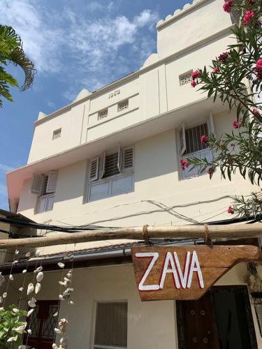a building with a zaan sign in front of it at Zava House Stone town in Zanzibar City