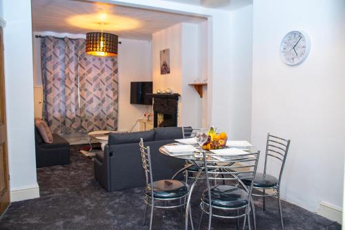 a living room with a couch and a table and chairs at ROYALE PLACE in Northampton