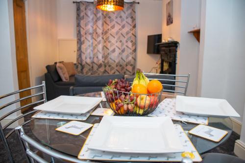 a glass table with a bowl of fruit on it at ROYALE PLACE in Northampton