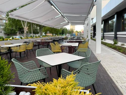 an outdoor seating area with tables and chairs at Impuls hotel in Vidin
