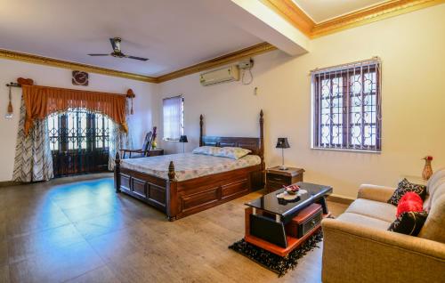 Großes Zimmer mit einem Bett und einem Sofa in der Unterkunft Stunning luxury Villa in Goa India in Colva