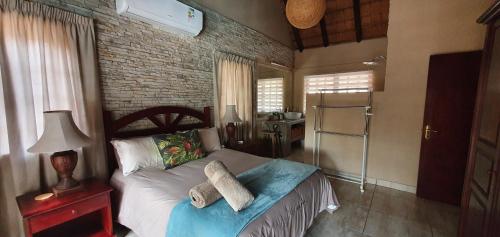 a bedroom with a bed with two towels on it at Loerie Escape - Marloth Park in Marloth Park
