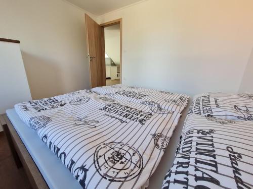 two beds sitting next to each other in a room at Holdudvar Apartman in Gyula