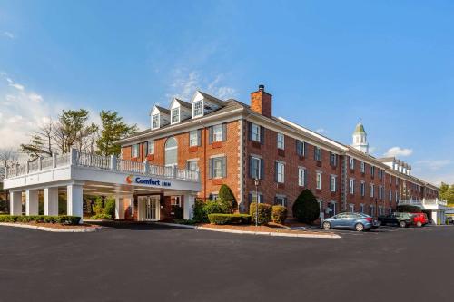 a large building with a clock on the front of it at Comfort Inn Rockland - Boston in Rockland