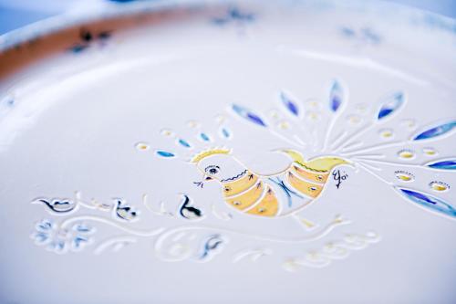 an illustration of a bird on a plate at Orosei Summer Holidays - Cala del Turco green house in Orosei