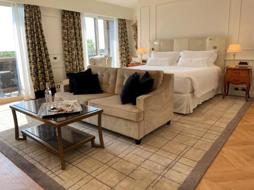 a bedroom with a bed and a couch and a table at Parco dei Principi Grand Hotel & SPA in Rome