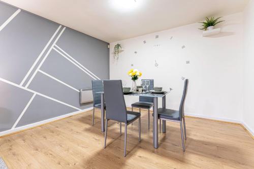 a dining room with a table and chairs at Riley House Spacious City Apartment in Coventry