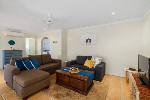 a living room with a couch and a coffee table at Laudable Lizzie in Sawtell