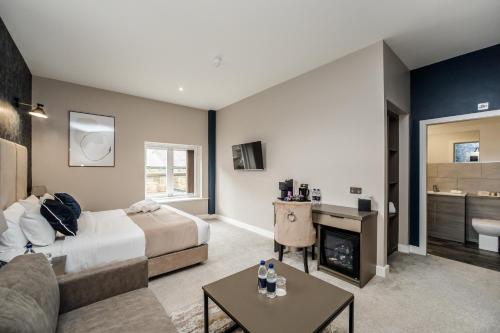 a bedroom with a bed and a living room at Stay Hotel in Huddersfield
