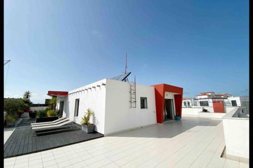 a white building with a cross on top of it at baleal penthouse in Ferrel