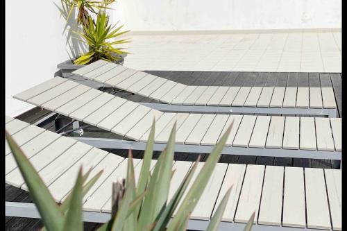 a row of steps on a building with plants at baleal penthouse in Ferrel