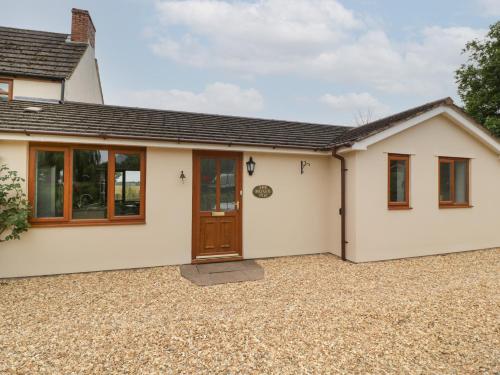 a detached house with a front door and windows at The Honey Pot in Chepstow