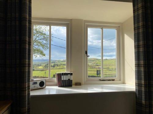 a room with a window with a view of a field at The Alma Inn in Colne