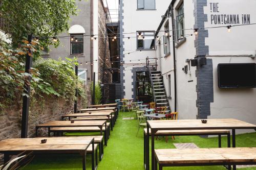 a row of tables and benches in an alley at Pontcanna Inn in Cardiff