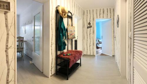 a hallway with a red bench in a room at Christianes Apartment - Ebstorf in Ebstorf