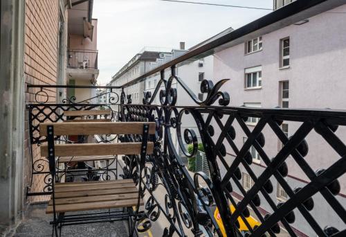 a couple of benches sitting on a balcony at HITrental Central Station Apartment in Zürich