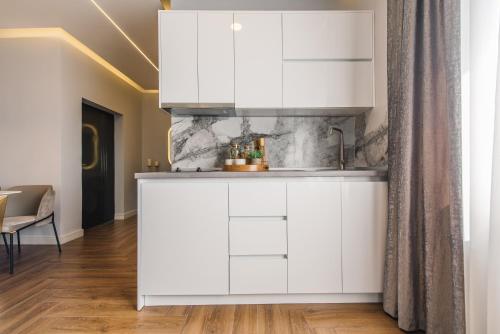 a kitchen with white cabinets in a room at Apartments Eneida in Ulcinj