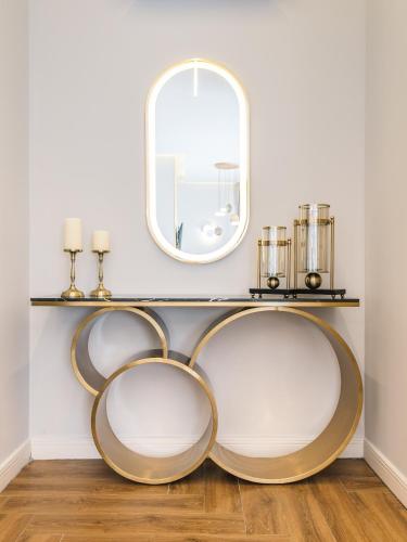 a round shelf with a mirror on a wall at Apartments Eneida in Ulcinj