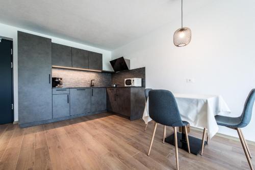a kitchen and dining room with a table and chairs at Chalet Kristall - Dolomites Garden Chalet in Falzes