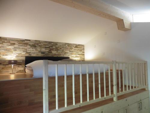 a bedroom with a bed and a brick wall at Leitingerhof in Virgen