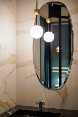 a bathroom with a sink and a mirror at Hôtel Singulier Bordeaux - Boutique Hôtel & Spa Anne Semonin in Bordeaux