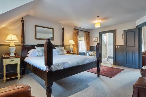 a bedroom with a large bed and a room with at The Hoste and The Vine House Hotels in Burnham Market