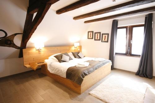a bedroom with a bed and a large window at App'Art - Le A in Kaysersberg