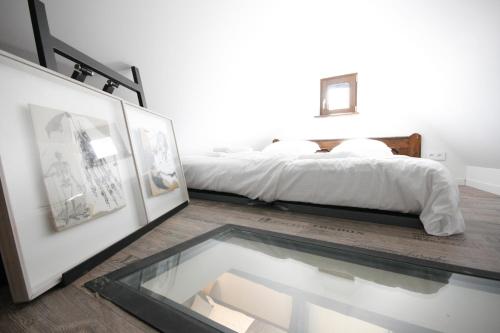 a bedroom with a bed and a glass table at App'Art - Le A in Kaysersberg