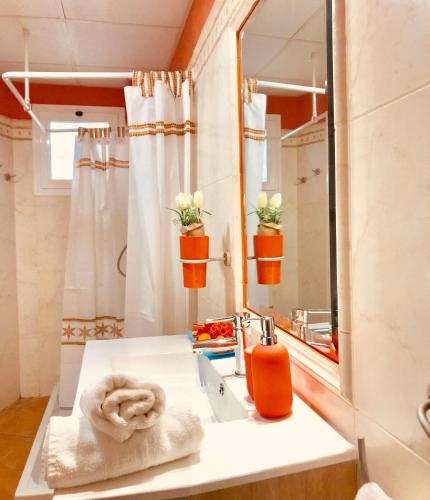 a bathroom with a sink and a mirror at Apartamento El Barco 1 linea PLAYA, PARKING, WIFI in Torrox Costa