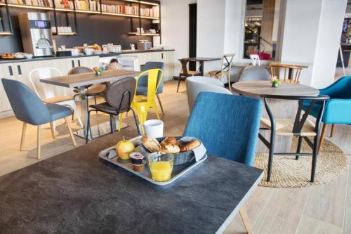 a tray of food on a table in a restaurant at Campanile Epinal Centre - Gare in Épinal