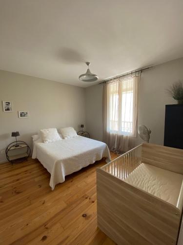 - une chambre blanche avec un lit et un canapé dans l'établissement Le Logis GOUT - L'Oustal, à Carcassonne