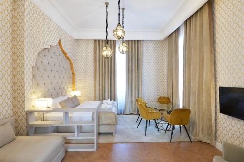 a hotel room with a bed and a table at 1552 Boutique Hotel in Eger