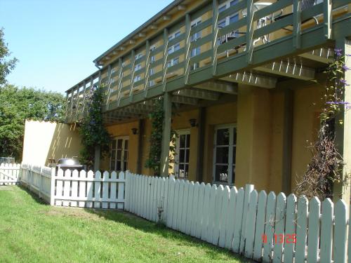 a white picket fence in front of a house at Munkebo B&B, Thy in Thisted