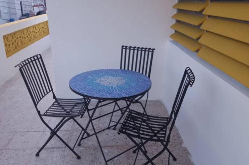 a table and two chairs and a blue table and chairs at Chill Family and Friend Escape with Wrap Around Porch in Rio Grande