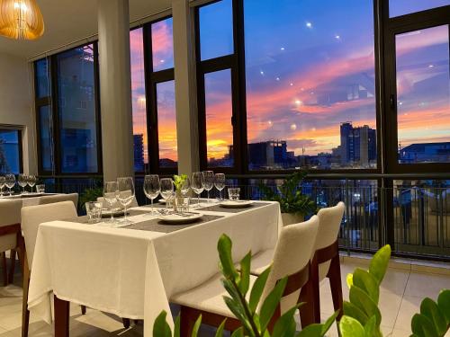 a dining room with a table with wine glasses at Indra Hotel in Phnom Penh