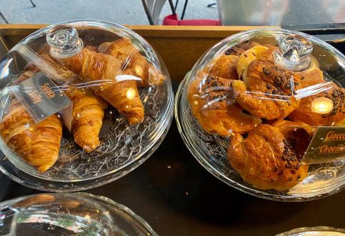 two trays of pastries are sitting on a counter at Suite boutique Moscova in Milan