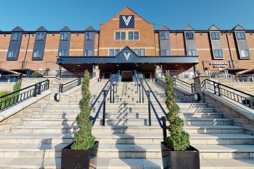 a building with stairs in front of a building at Village Hotel Manchester Bury in Bury