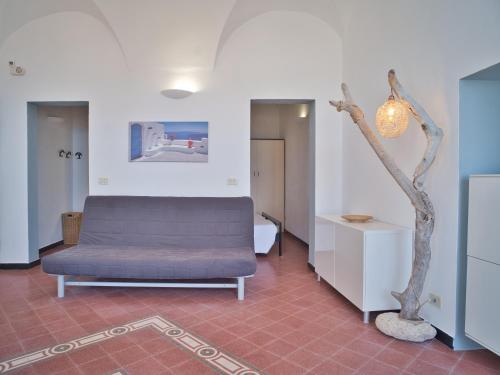 a room with a bed and a tree in it at Medusa Apartment - Piazza 1 in Finale Ligure