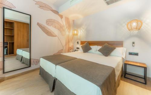 a bedroom with a bed and a large mirror at DWO Nopal in Puerto de la Cruz