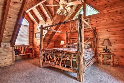 a bedroom with a bed in a log cabin at Pigeon Forge Getaway with Covered Patio and Hot Tub! in Pigeon Forge