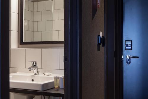 a bathroom with a sink and a mirror at Pointe Isabelle in Chamonix-Mont-Blanc