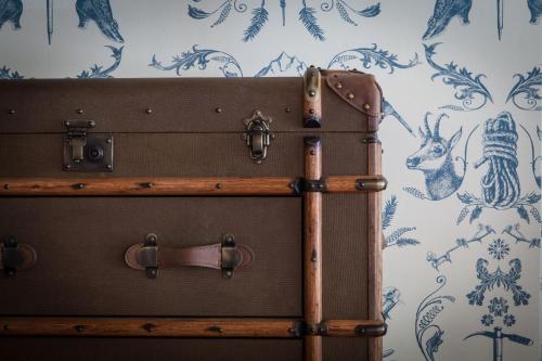 two suitcases stacked on top of each other against a wall at Pointe Isabelle in Chamonix-Mont-Blanc