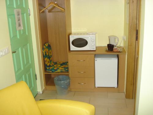 a small kitchen with a microwave on top of a counter at Vinland Guesthouse in Egilsstadir