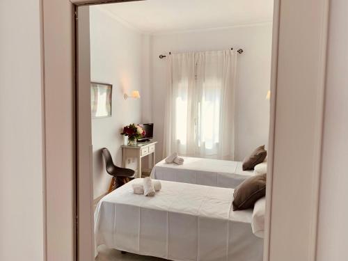 a mirror reflection of a bedroom with two beds at Hotel Doña Blanca in Seville