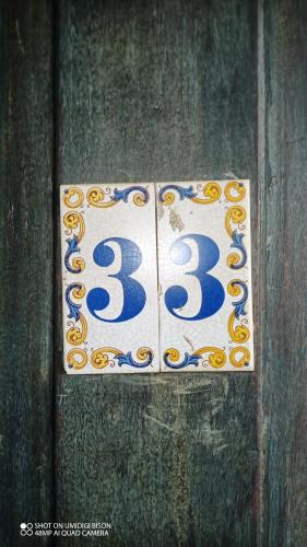 a sign on a wooden door with the number at Vila Santa Rosa Guest House in Ilhabela