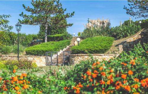 a stone staircase in a garden with orange flowers at Casa Vacanze con piscina - Villa Bentivoglio in Morrovalle
