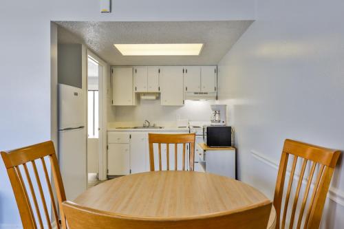 a kitchen with a wooden table and chairs in a room at Coastal Waters in New Smyrna Beach
