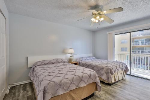 a bedroom with two beds and a ceiling fan at Coastal Waters in New Smyrna Beach