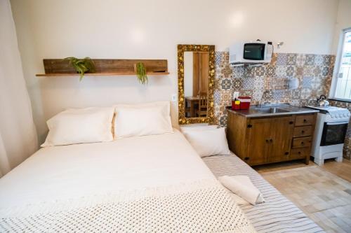 Säng eller sängar i ett rum på Hospedagem Morada Nativa Praia Bombas