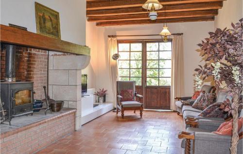 a living room with a brick fireplace and a couch at Beautiful Home In Durfort Lacapelette in Durfort